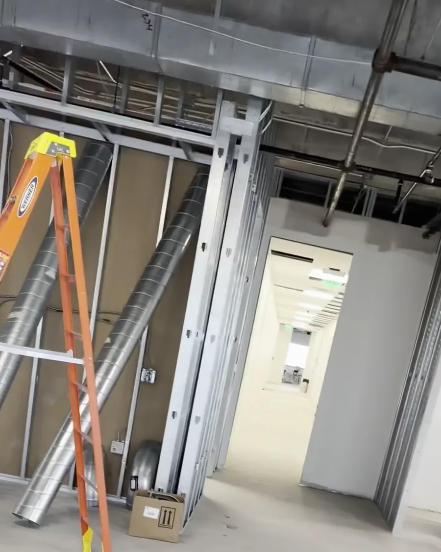 New office framing with spiral supply duct during a Houston high-rise tenant finish