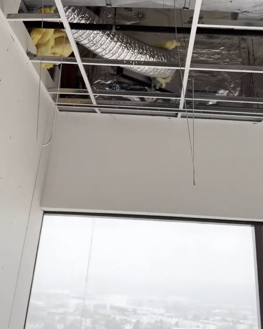 Open ceiling with new HVAC ductwork above a downtown Houston office during a tenant finish